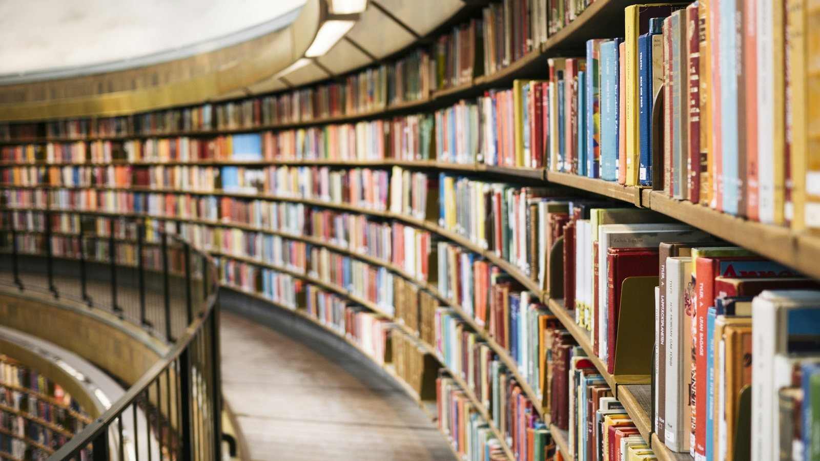 Curved library bookshelves filled with books